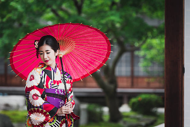 A shy and beautiful young Japanese woman at a temple in Kyoto, Japan.