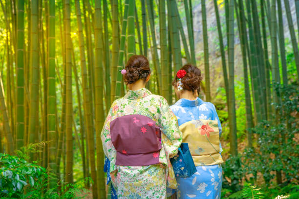 Kamakura, Japan - April 23, 2017: Women wearing Japanese kimono walking in bamboo garden of Take-dera Hokoku-ji Temple of Kamakura. Japanese culture and lifestyle on spring season.